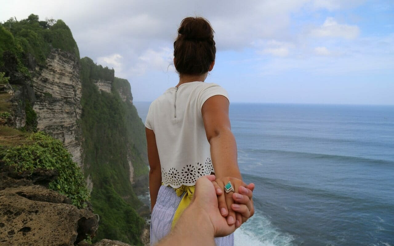 cliff, beach, holding hands