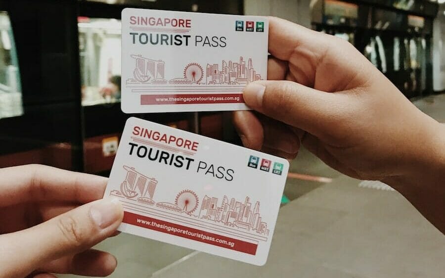 person holding tourist pass tickets