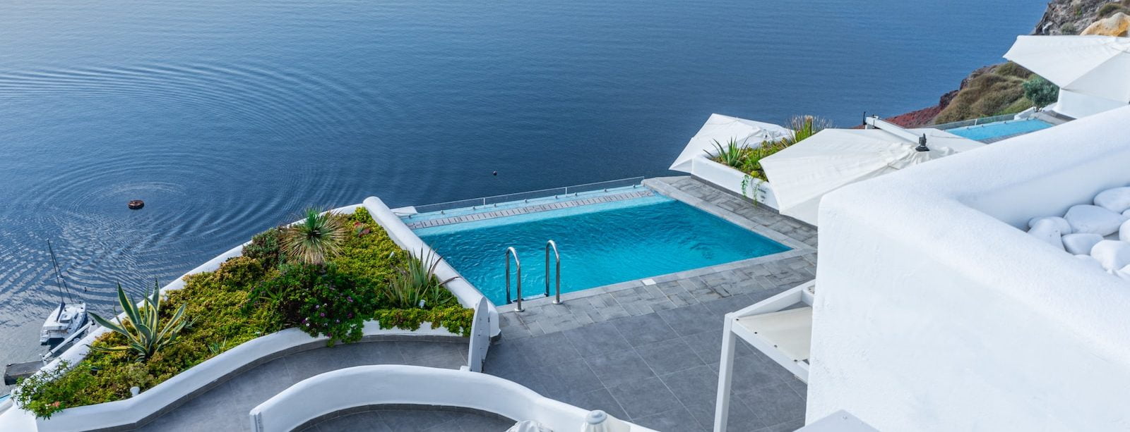 white concrete swimming pool near a body of water. Subscribe to our newsletter today