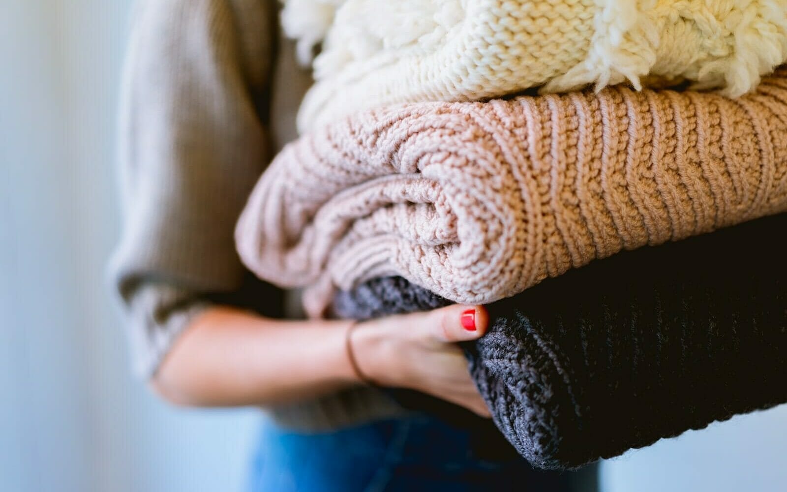 person holding knitted textiles