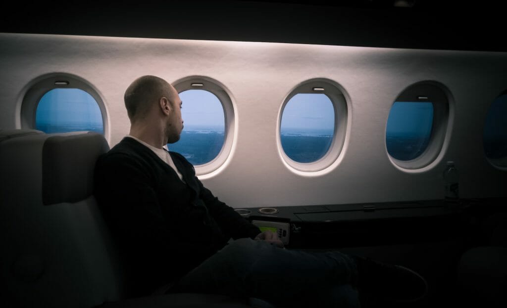 man seating near window