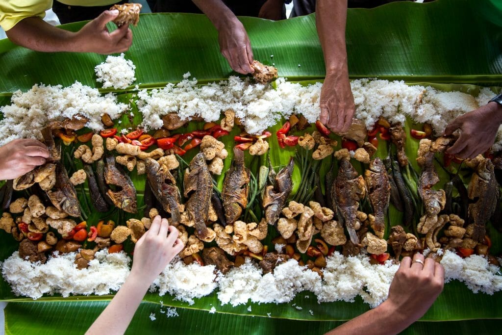 photo of people eating rice while enjoying International Food and Wine