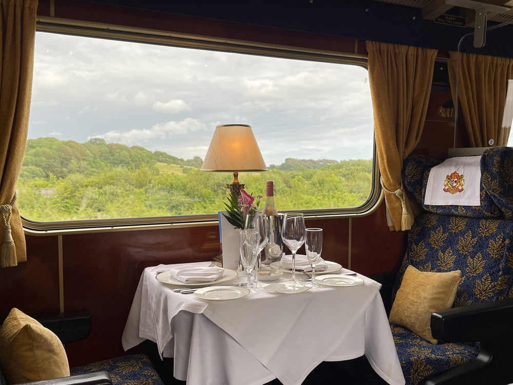 Poole, Dorset, England - July 2021- Formal table setting for dinner in a luxury train operated by Statesman Rail, a charter rail company.