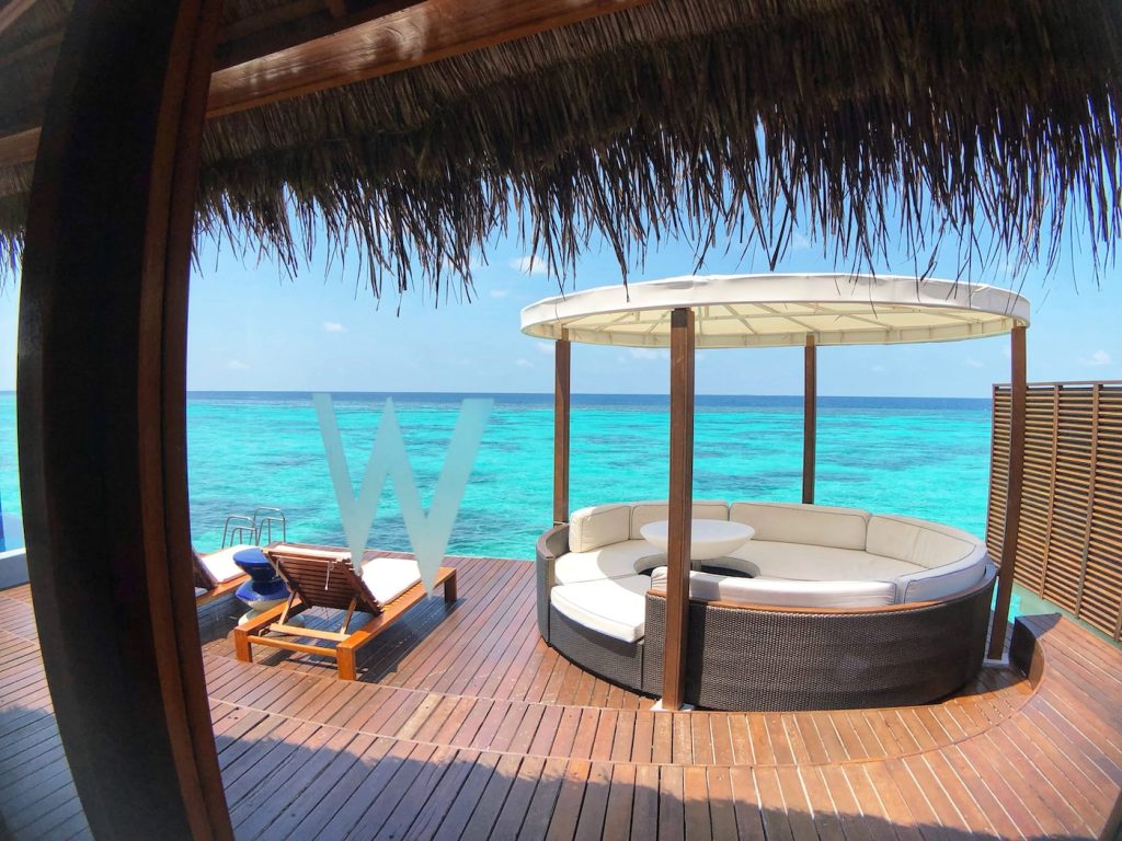 Enjoying Luxury Vacation Spots in the Maldives white and brown wooden lounge chair near swimming pool during daytime