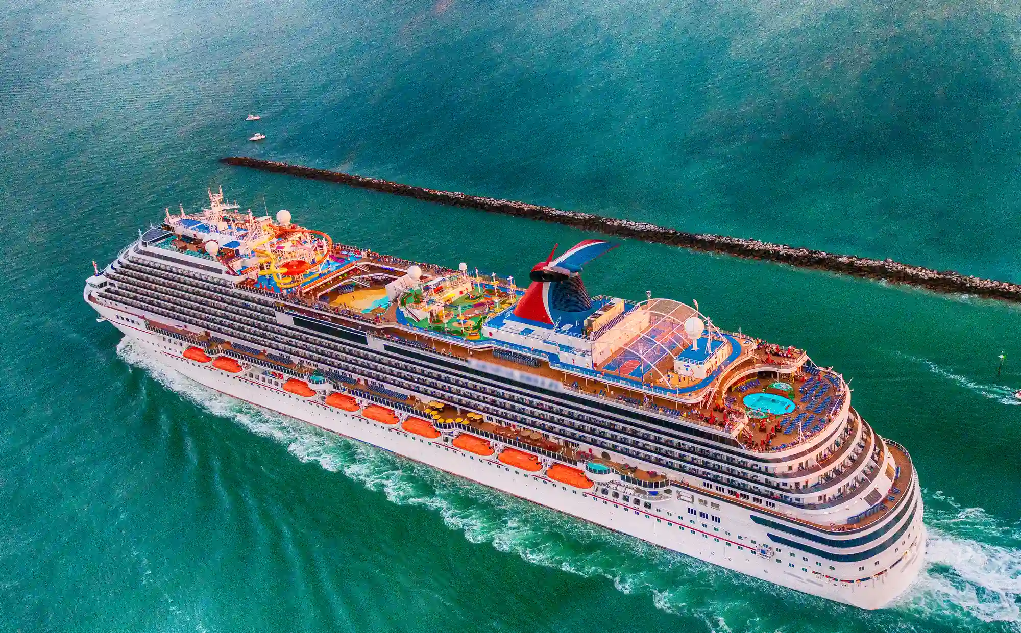 An aerial view of a large luxury Caribbean Cruise ship in the ocean.
