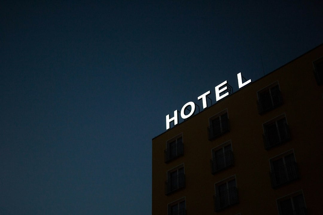 A hotel sign on a building at night.