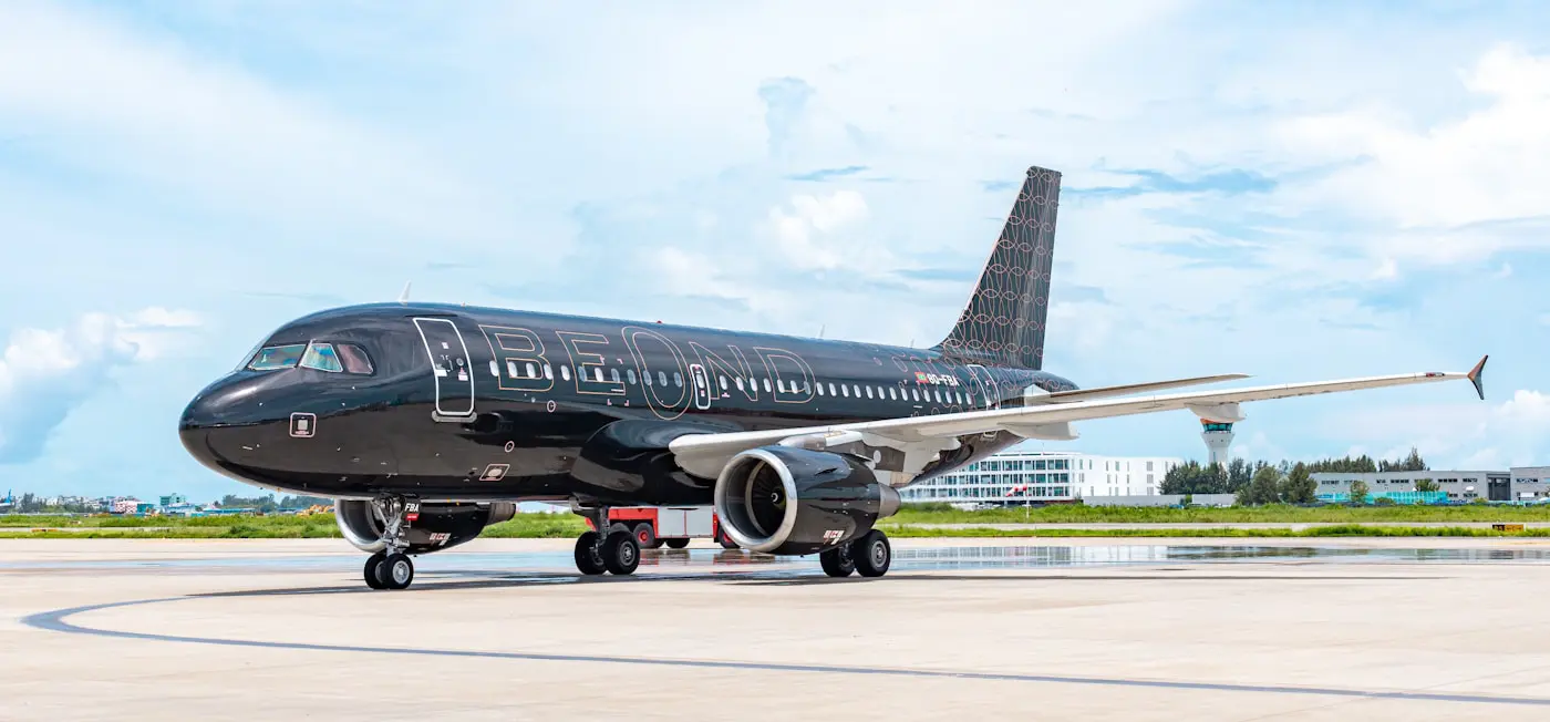 A black airplane on a tarmac with beond Apple Vision Pro.