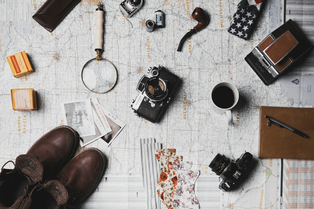 A pair of brown shoes, a coffee cup, a map, and a pair of sunglasses: Tips for Solo Travelers.