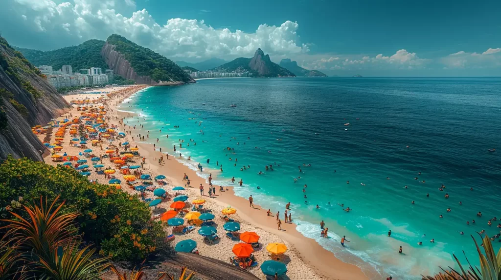 A vibrant beach scene with colorful umbrellas and numerous people swimming and relaxing on the sandy shore. The turquoise ocean meets the sky, with lush green mountains and city buildings visible in the background under a partly cloudy sky.
